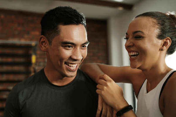 Gym partners smiling together