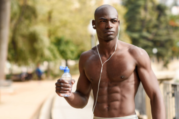 Muscular man with water bottle in hand
