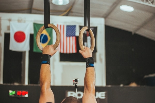 Man hanging from gymnastic rings
