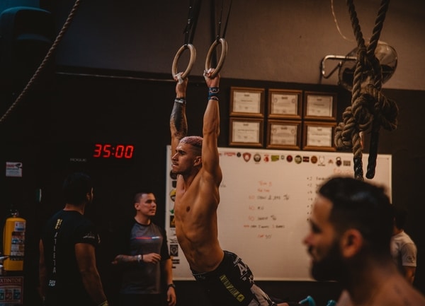 Man in gym using rings