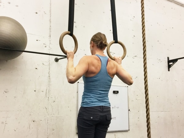 Woman using gymnastics rings