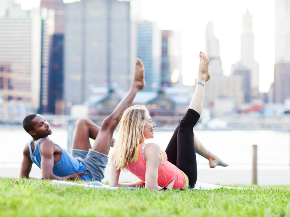 man and woman stretching before workout