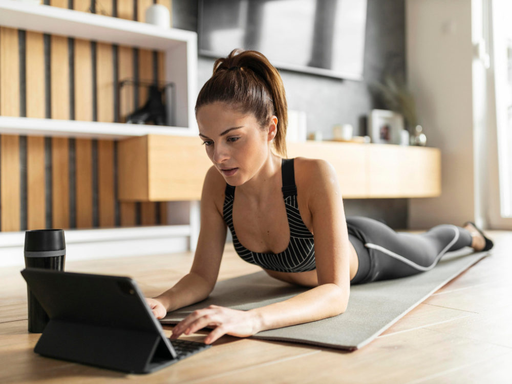 woman researching workouts on laptop