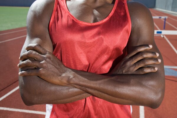 man showcasing chest and arm muscles