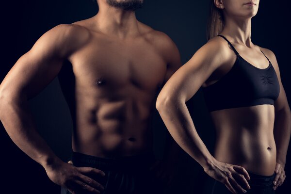 man and woman showing muscles