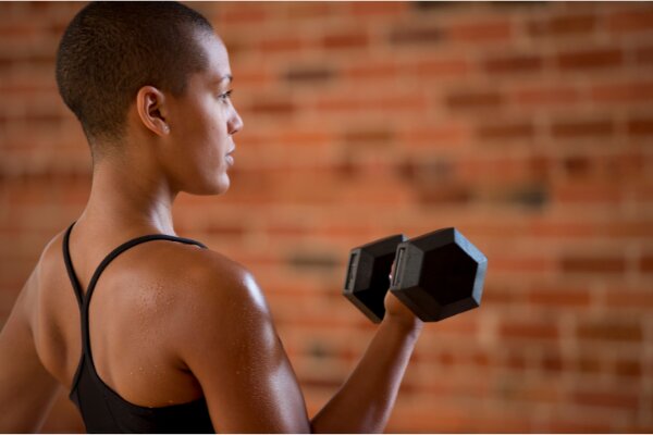 young lady performing free weights workout