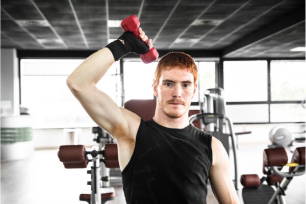 man performing free weights exercises