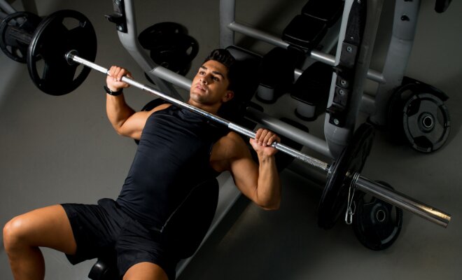 man doing close grip bench press