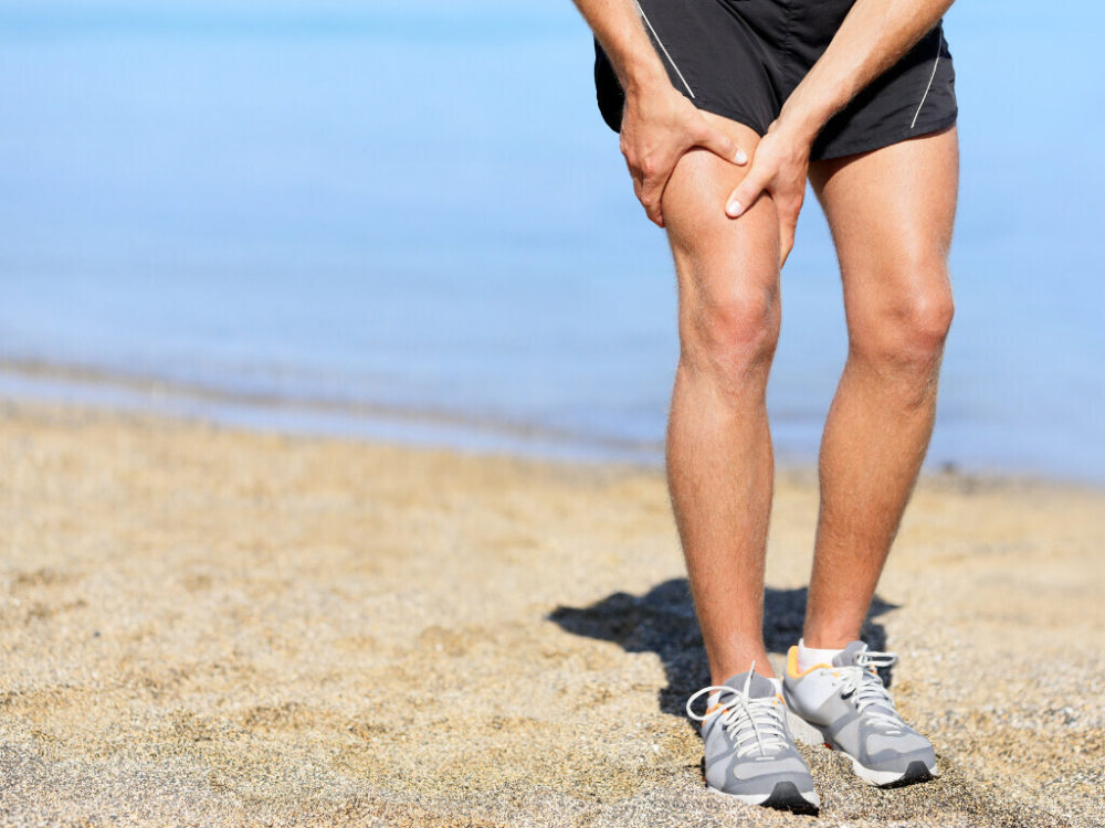 showcase of leg muscles on the beach