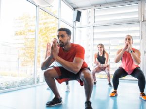 squatting with a group of people