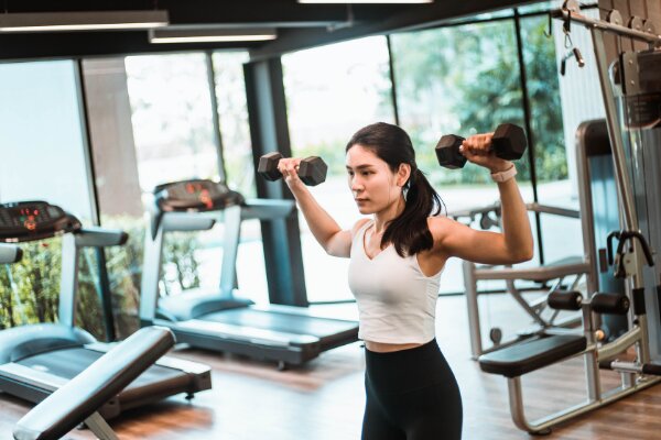 woman performing free weight workout alone