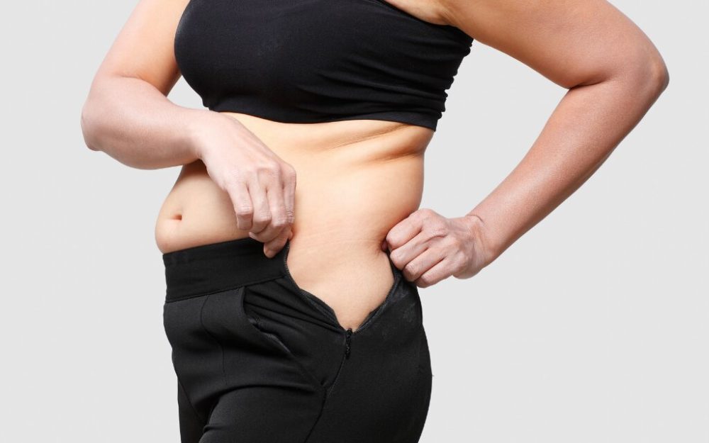 woman trying to zip bottoms