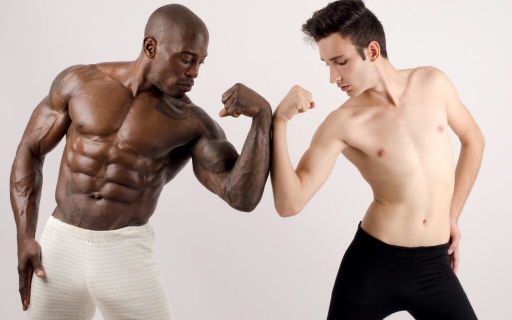 two men showing off their muscles