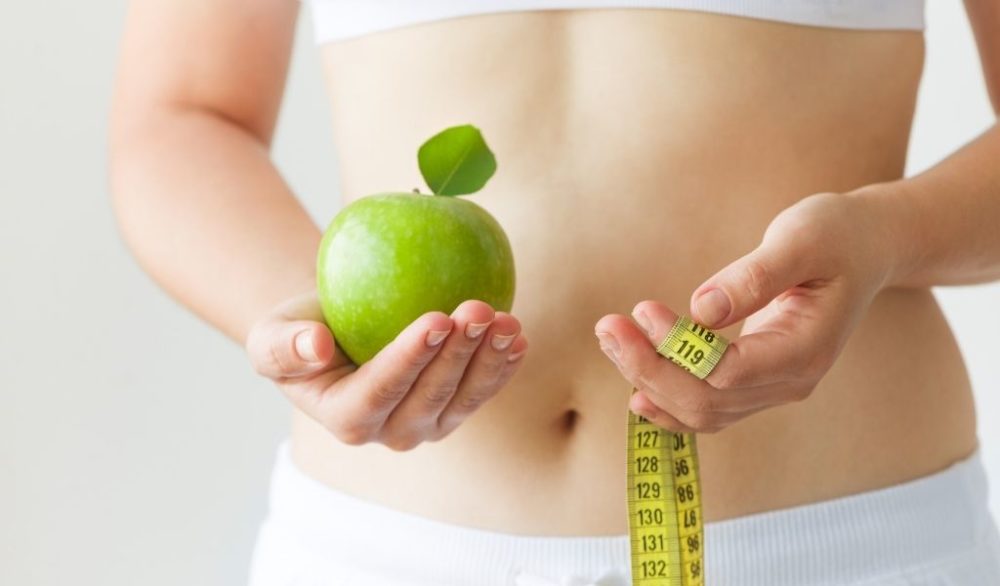 dieting and exercise apple and tape measure