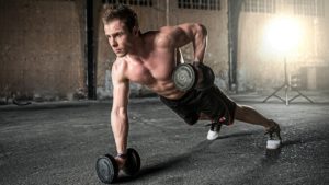 man doing single rows on the floor