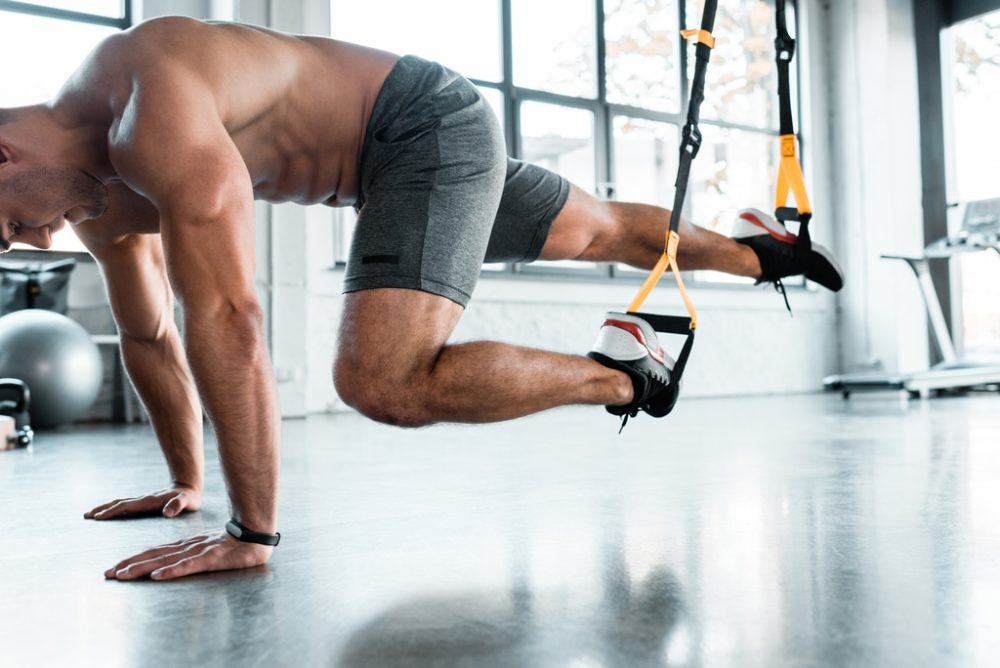 Man using suspension trainer