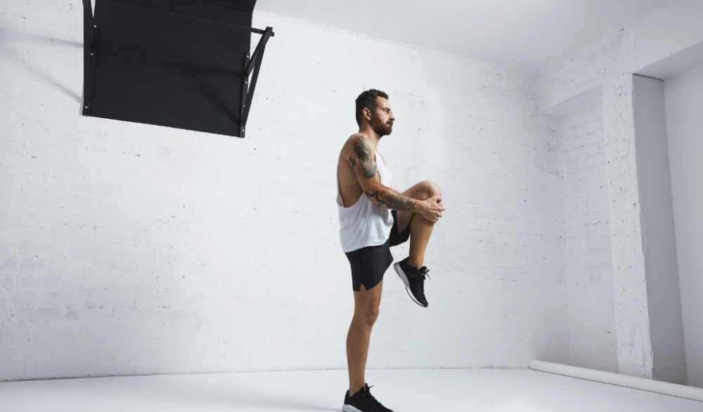 man stretching as part of beginner calisthenics program