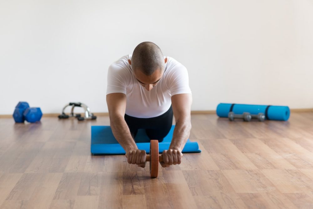 Man using ab roller head on