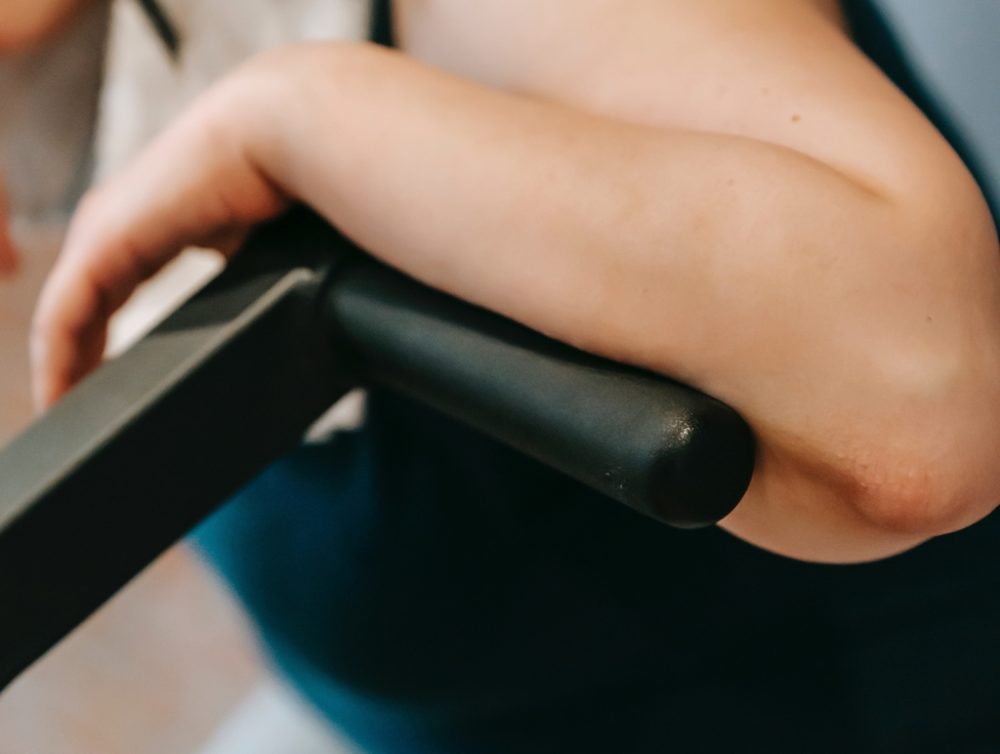 Person leaning arm on bike handle