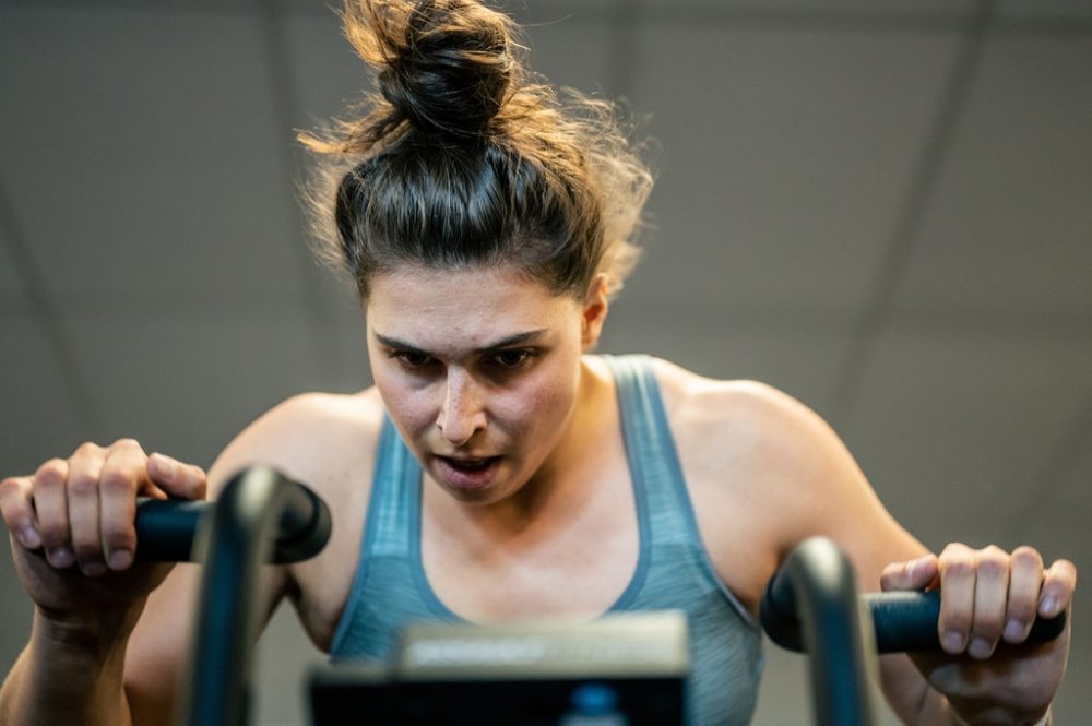 Woman concentrating on air bike