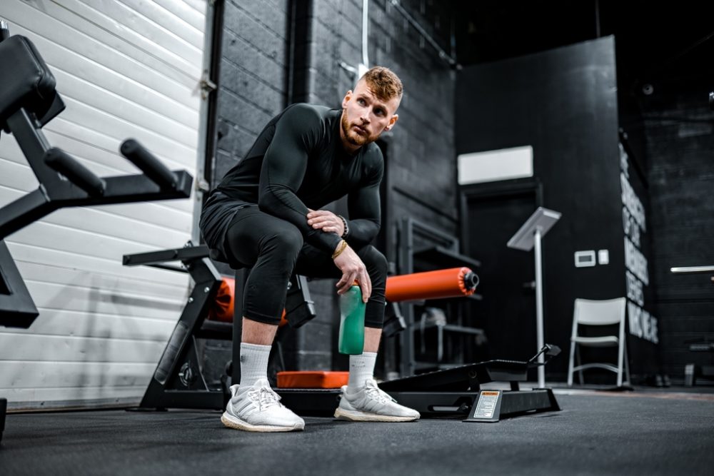 Man resting on equipment waiting to jump on Bowflex C6