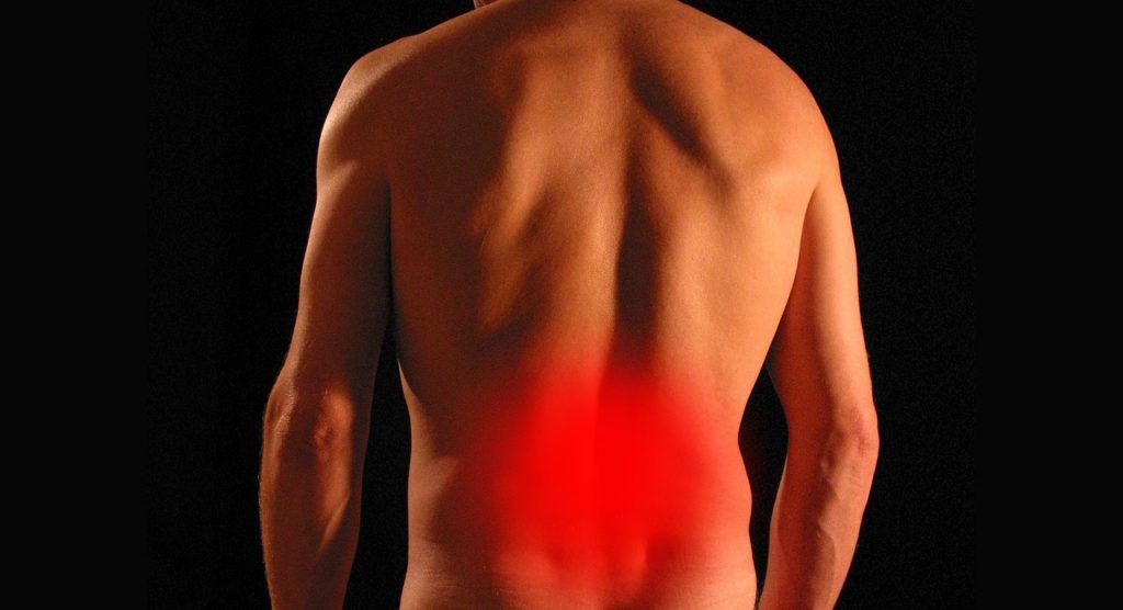 Lower back pain shown in man