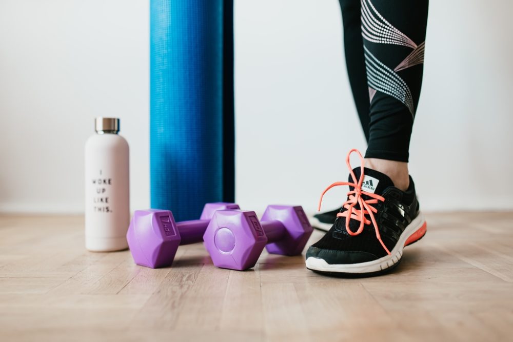 Person's leg by dumbbells
