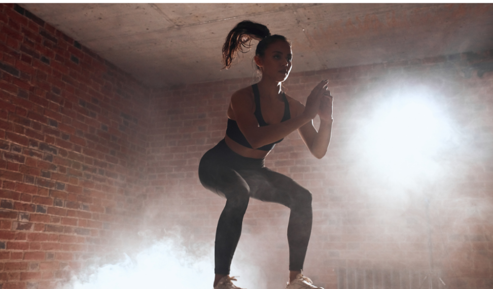 Woman with calisthenics physique doing box jump