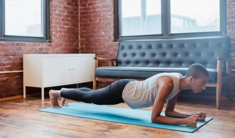 Woman performing a plank in living room