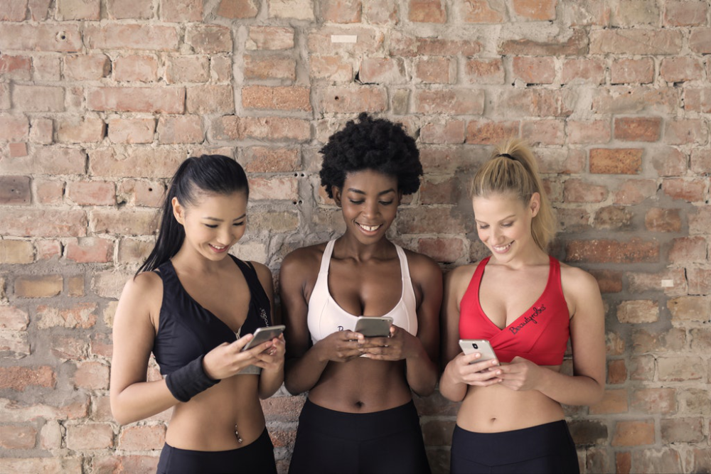 Gym ladies looking at their phones