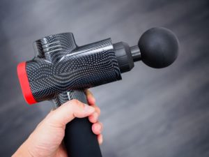 Hand holding a massage gun