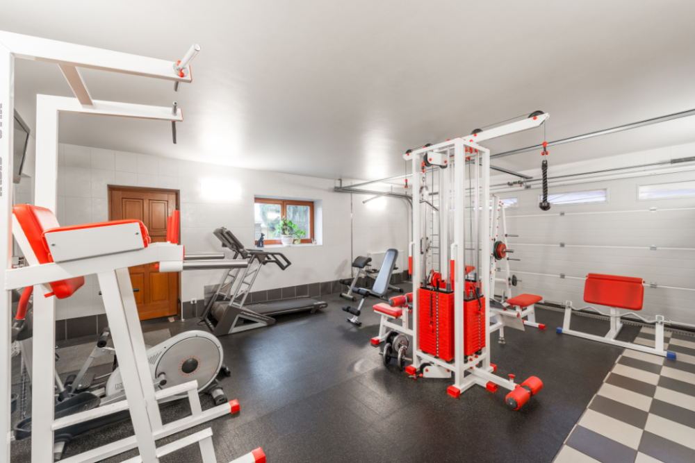 Home gym with red equipment and ghd machines