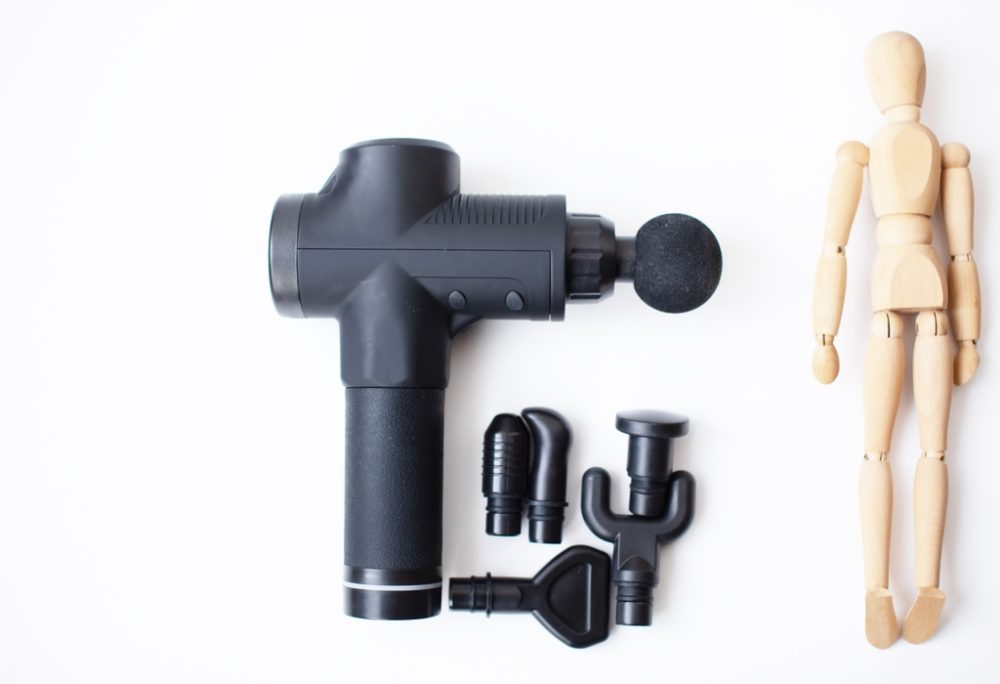 Best massage gun next to a figurine