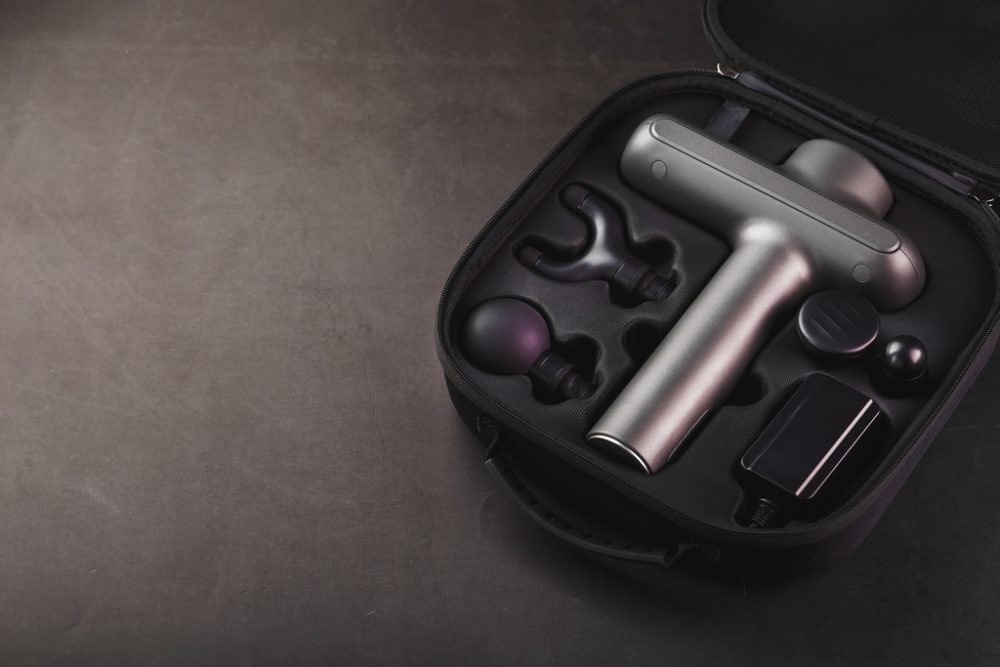 Massage gun in case with attachments