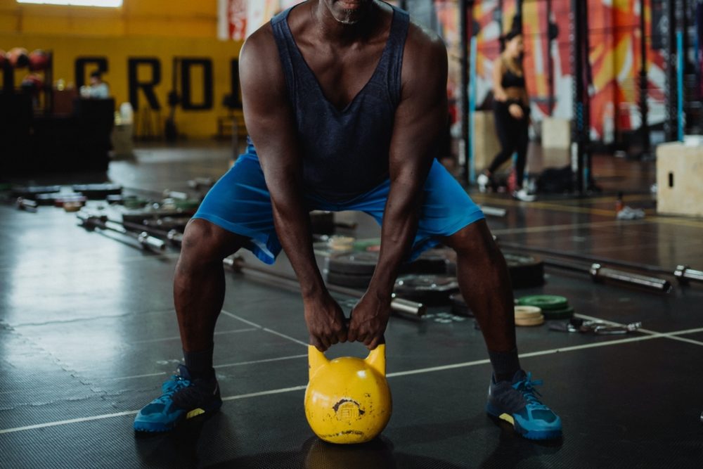 Man lifting kettle bell