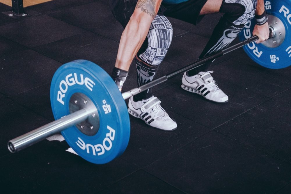 Close up of Rogue bar and weightlifting shoes