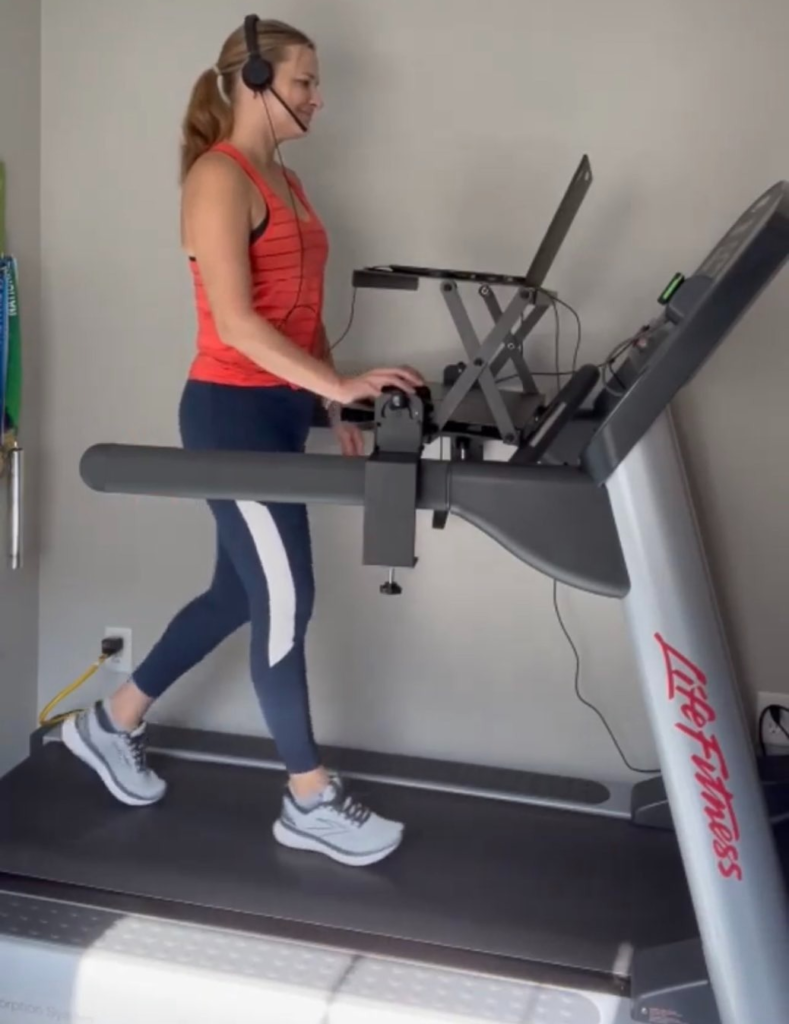 Woman-walking-on-treadmill-with-laptop-desk-attachment