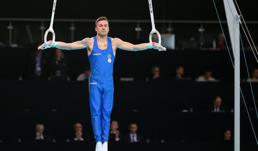 Man doing an iron cross gymnastics exercise