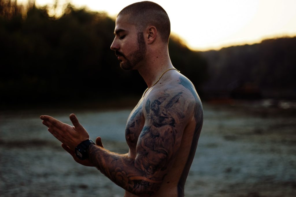 Man with tattooed biceps