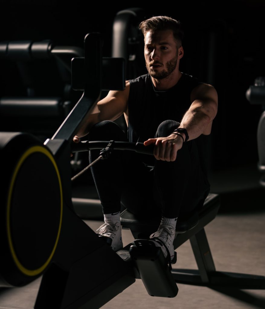 Man rowing indoors