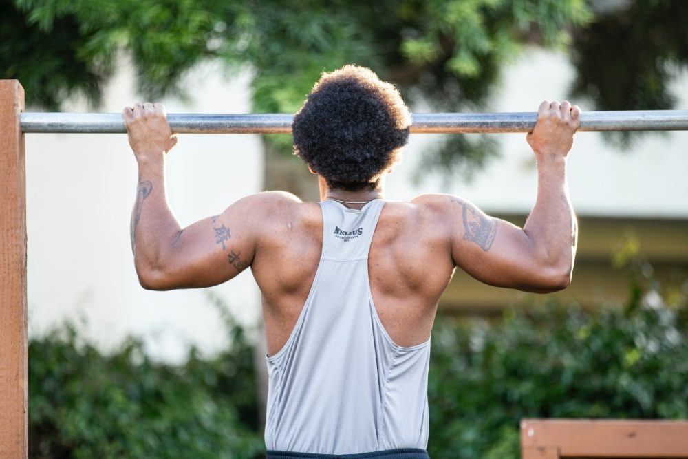 Man doing a pullup in nature