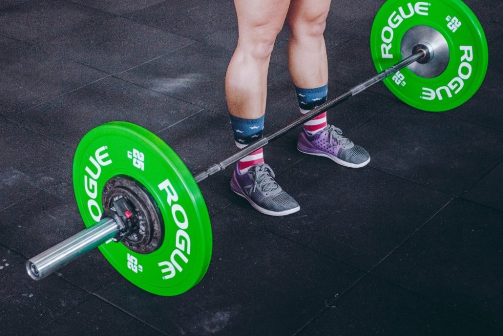 Rogue fitness barbell on floor for a pull day workout