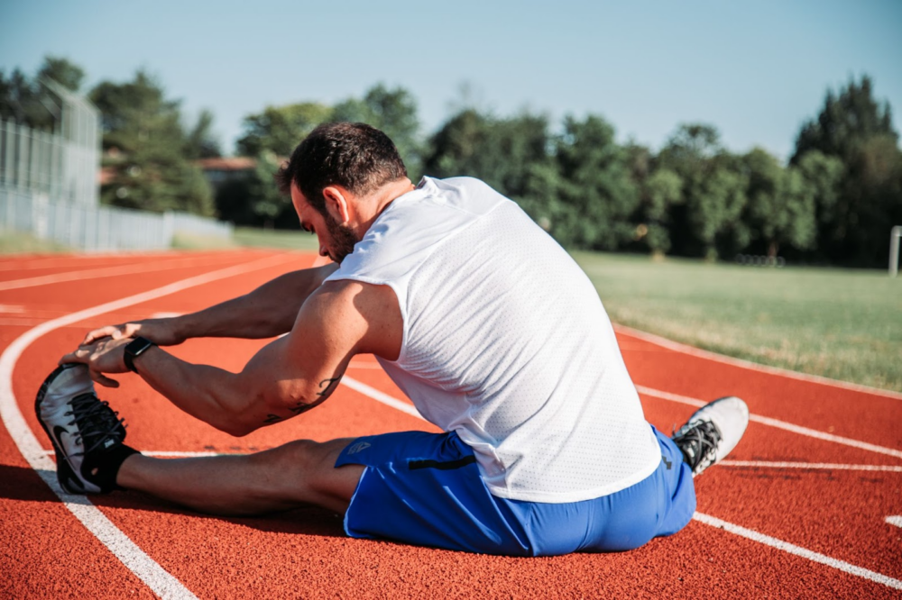 man doing stretching therapy outside
